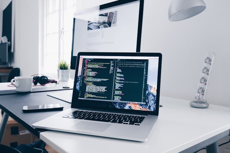 Developer focused on code at a laptop